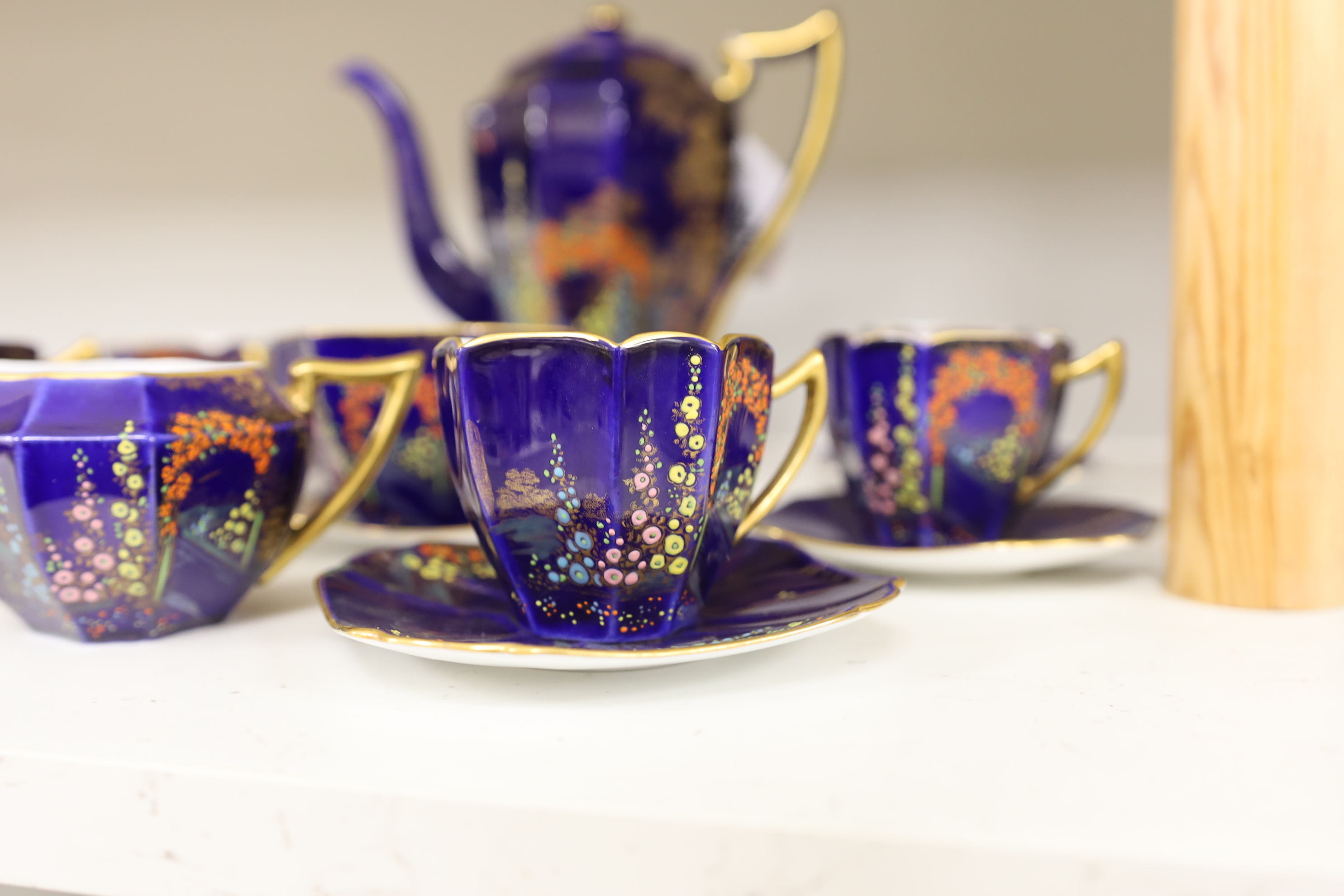 A 1930’s Shelley floral and gilt part coffee set (one cup missing), coffee pot 19cm high